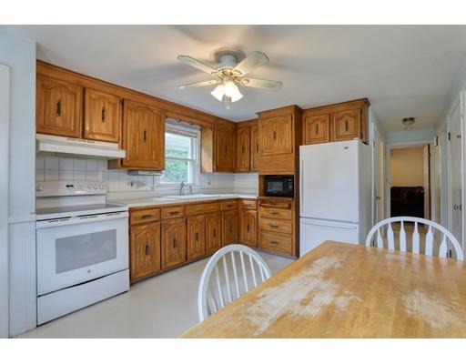 72 Burt Road Springfield, MA 01118 - Photo 4 of 19 a kitchen with stainless steel appliances granite countertop a refrigerator a sink dishwasher a stove and white cabinets with wooden floor