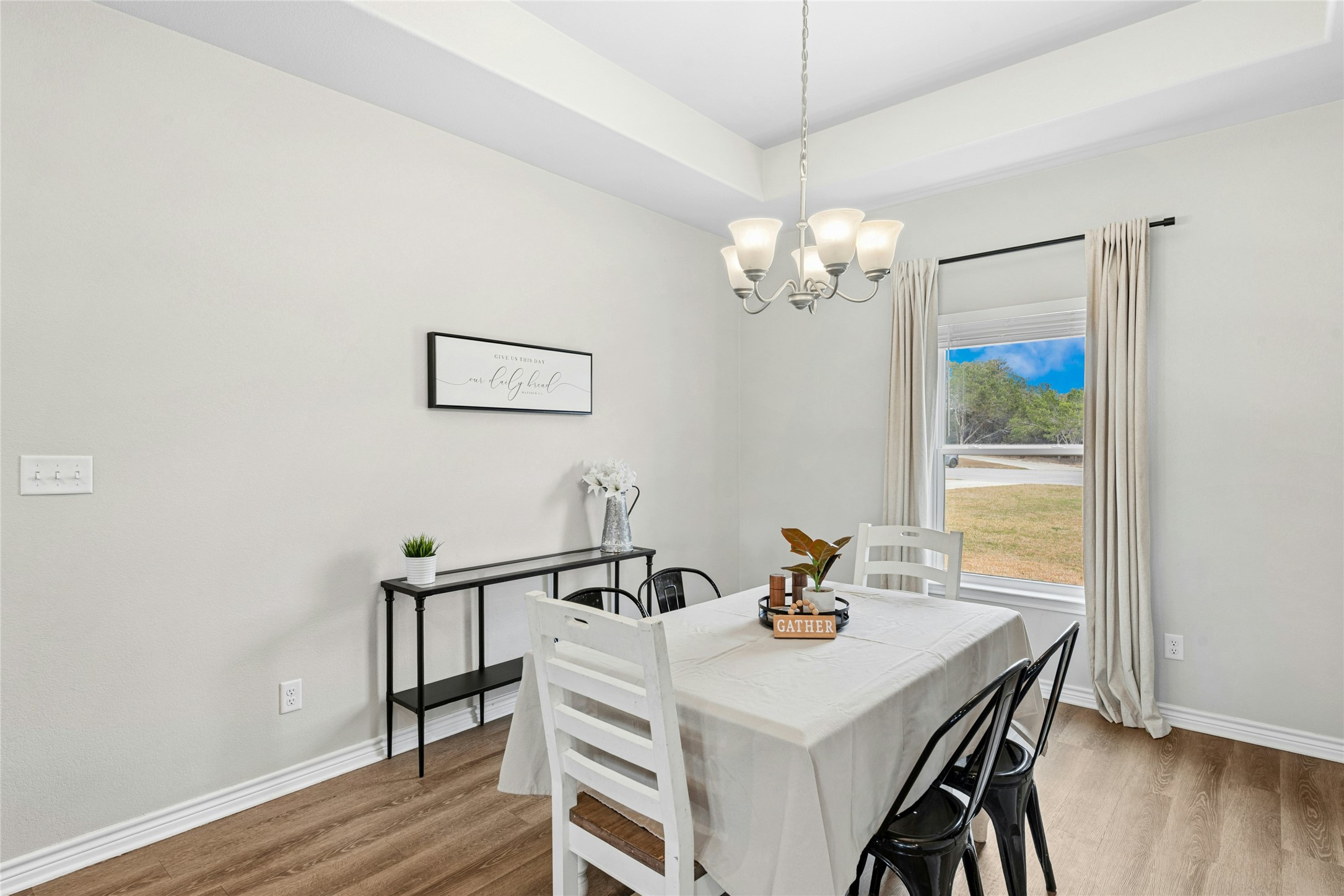 195 Rosebud Ranch Road Bertram, TX 78605 - Photo 13 of 40 a view of a dining room with furniture wooden floor and chandelier