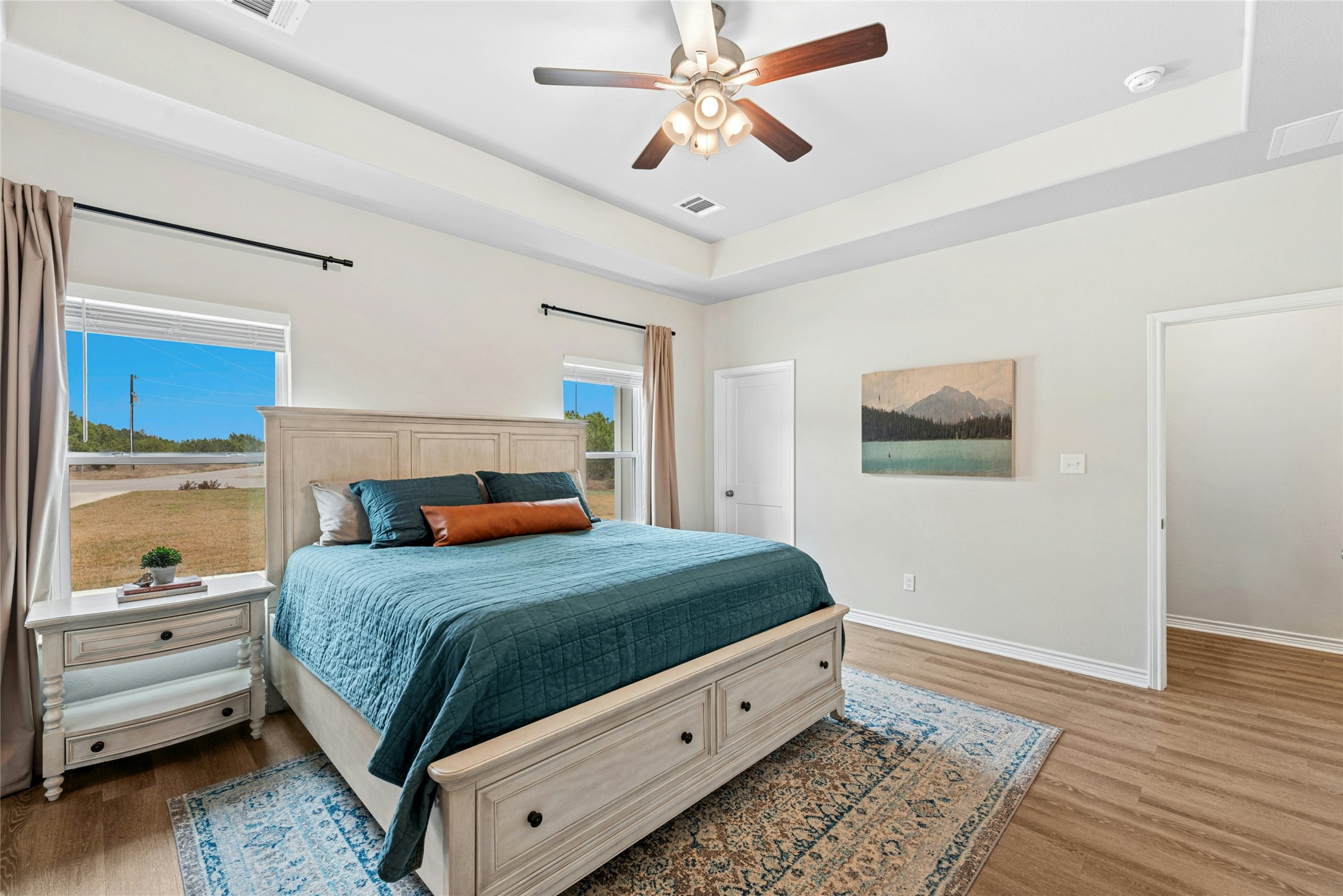 195 Rosebud Ranch Road Bertram, TX 78605 - Photo 22 of 40 a bedroom with a bed and large window