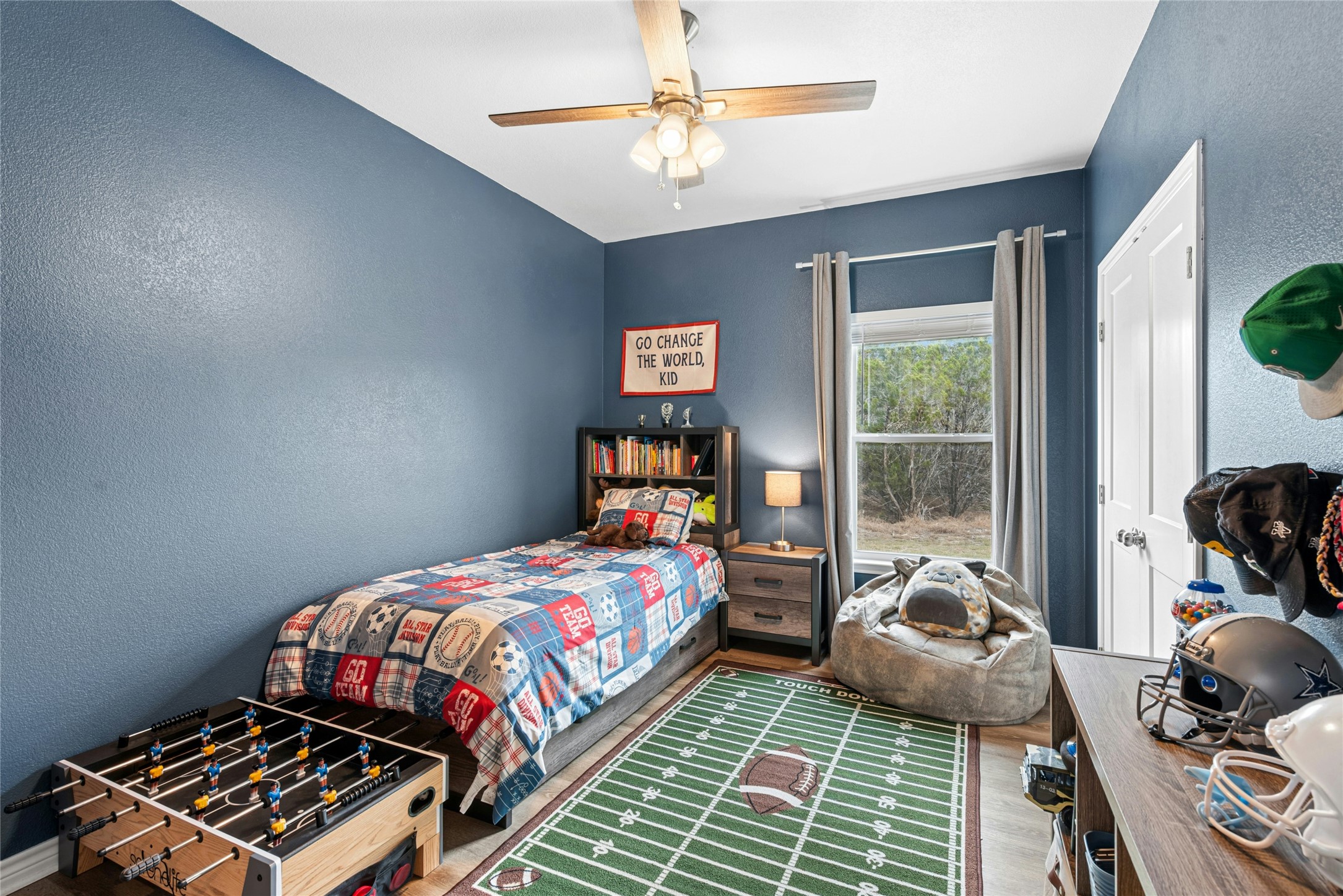 195 Rosebud Ranch Road Bertram, TX 78605 - Photo 29 of 40 a bedroom with a bed and wooden floor