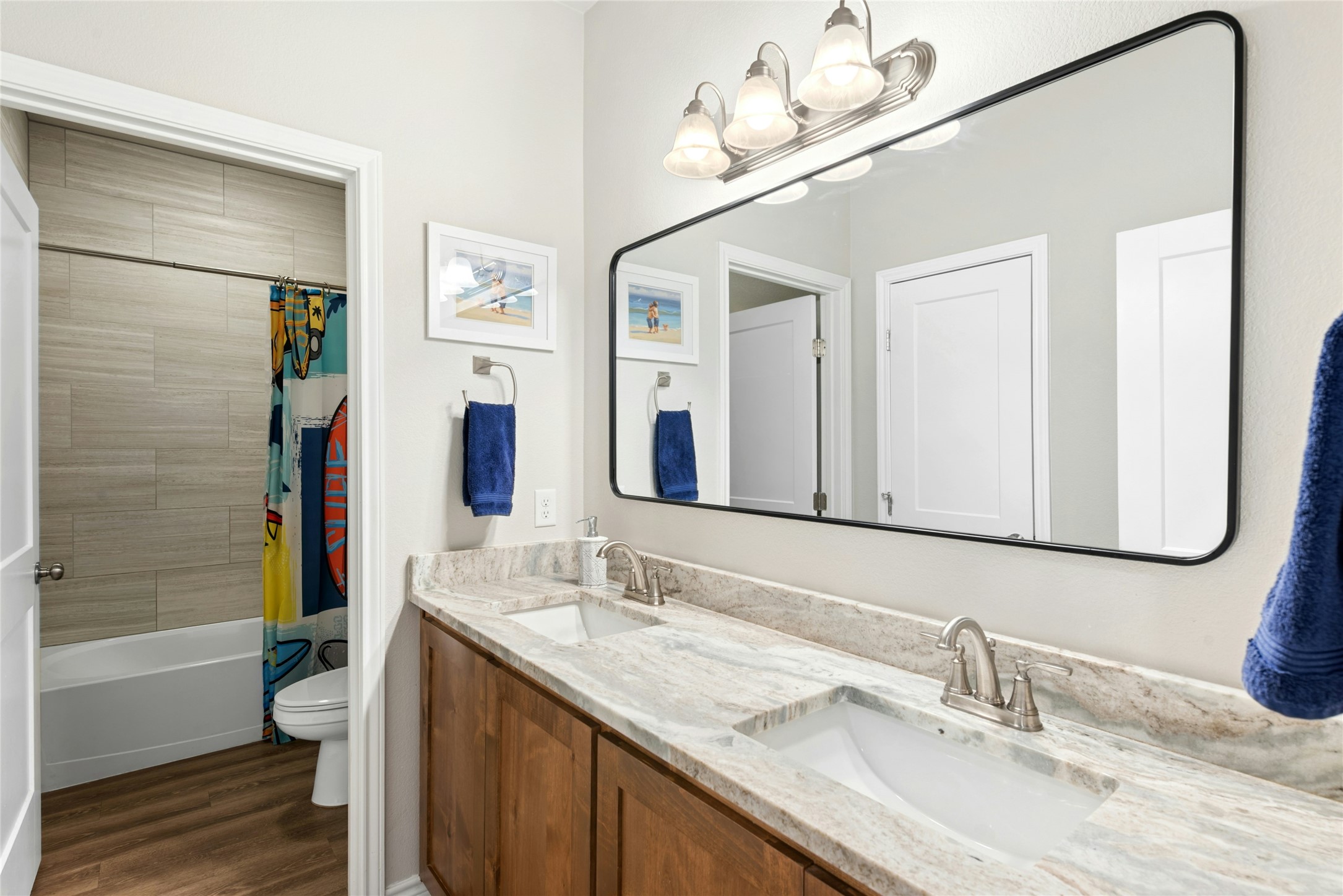 195 Rosebud Ranch Road Bertram, TX 78605 - Photo 32 of 40 a bathroom with a granite countertop sink a mirror a bathtub and shower