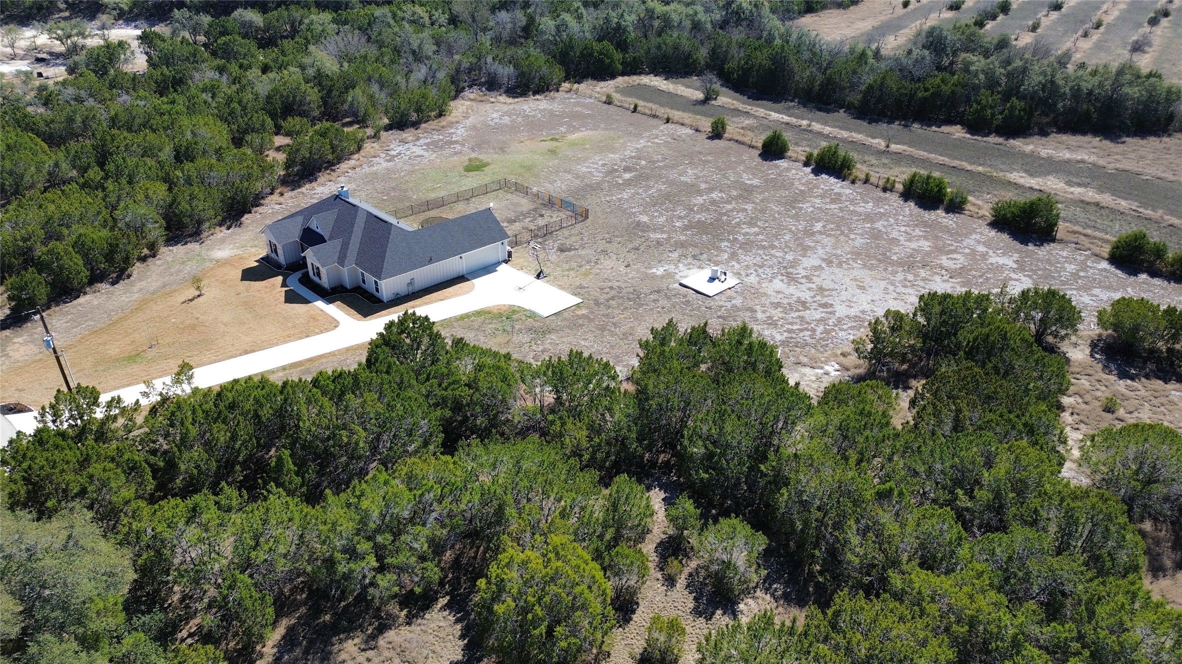 195 Rosebud Ranch Road Bertram, TX 78605 - Photo 38 of 40 a view of a dry yard with large trees