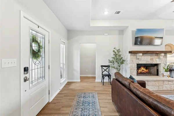 a living room with furniture and a fireplace