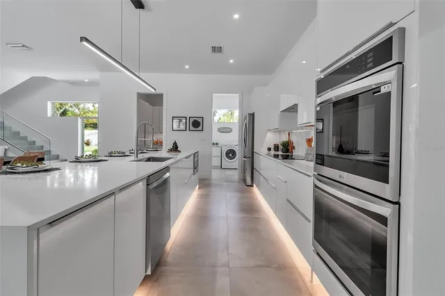 a spacious bedroom with a bed a table and a large window