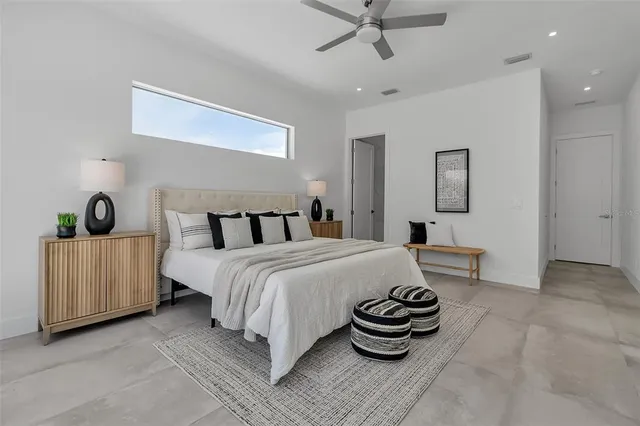 a bedroom with a bed and a large window