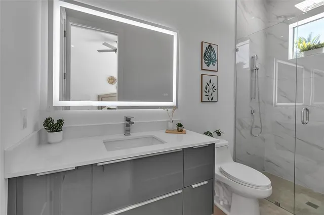 a view of an empty room with a ceiling fan