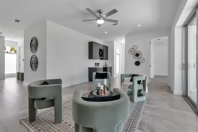 an empty room with a ceiling fan and window