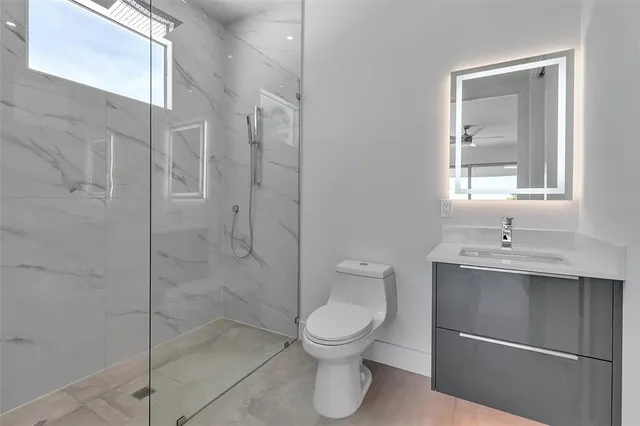 a room with a window and ceiling fan