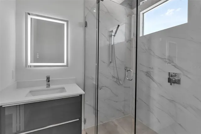 a living room with patio furniture and a potted plant