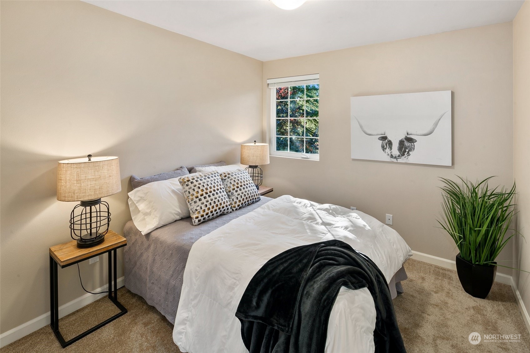 14704 Simonds Road Northeast Bothell, WA 98011 - Photo 23 of 40 a bedroom with a bed and a potted plant