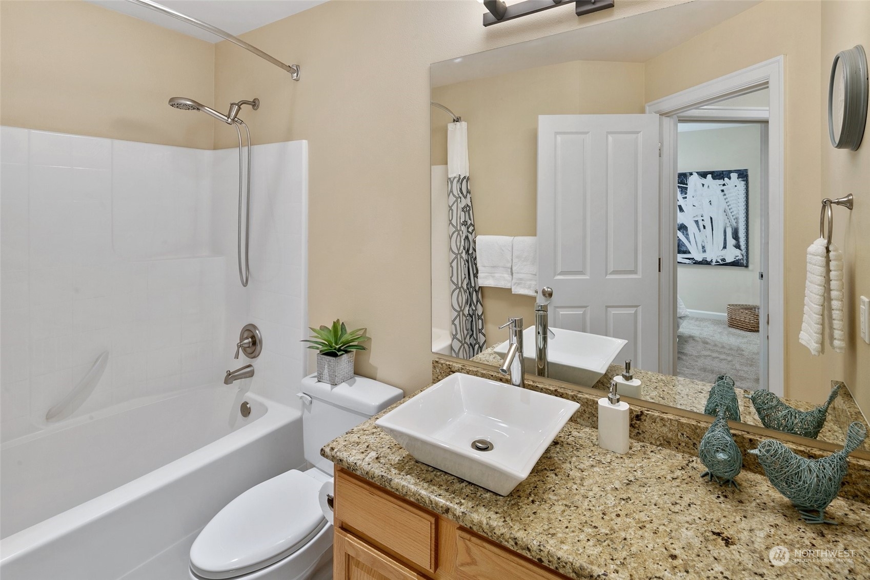 14704 Simonds Road Northeast Bothell, WA 98011 - Photo 25 of 40 a bathroom with a granite countertop sink a toilet and bathtub
