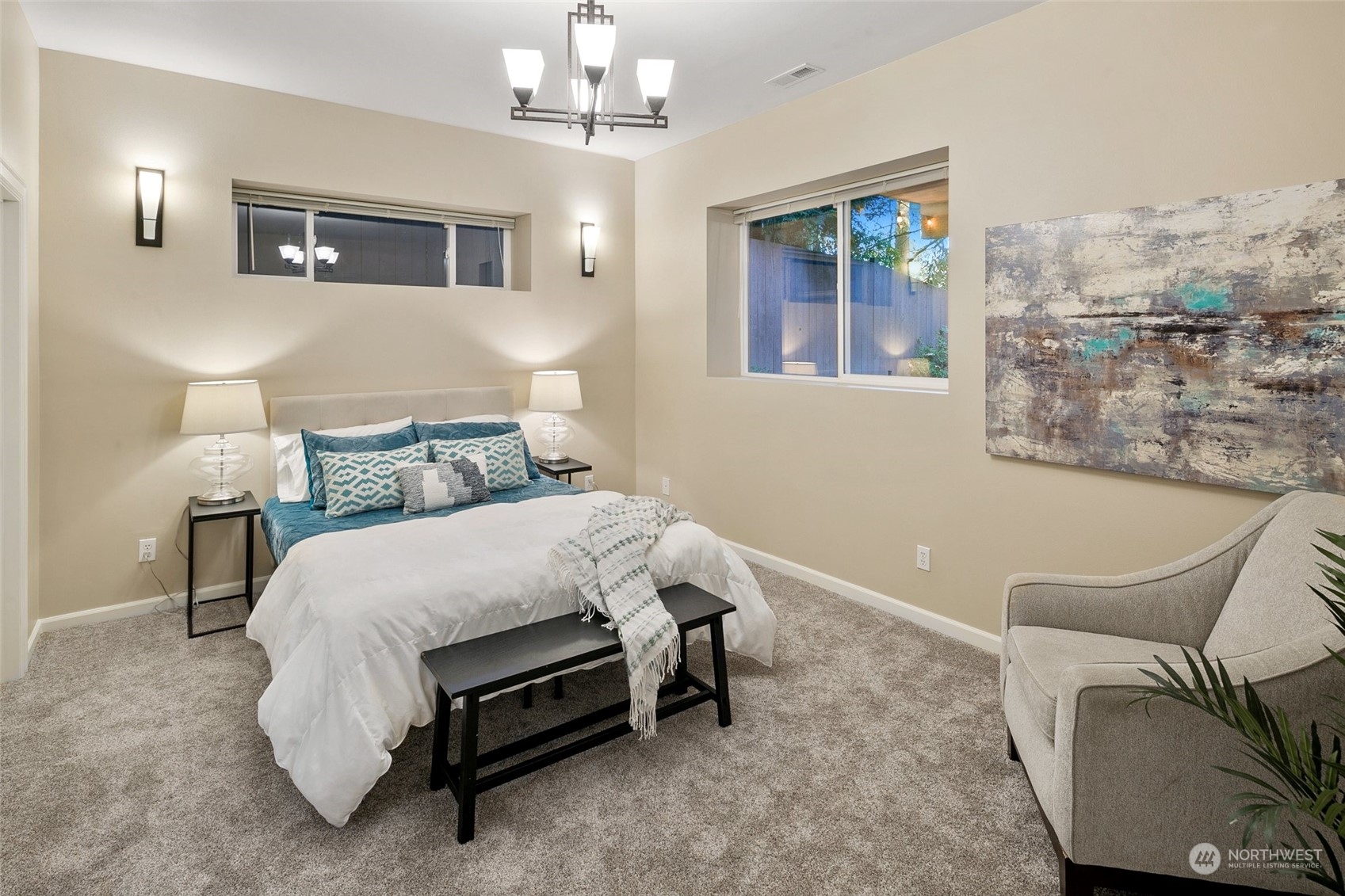 14704 Simonds Road Northeast Bothell, WA 98011 - Photo 30 of 40 a bed sitting in a spacious bedroom next to a window and a chandelier