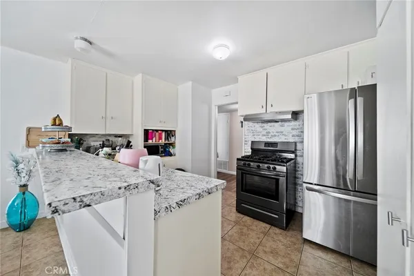 a kitchen with stainless steel appliances granite countertop a stove and a sink
