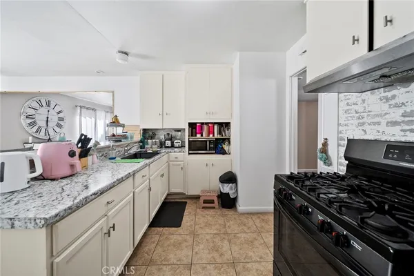 a kitchen with stainless steel appliances granite countertop a sink and cabinets