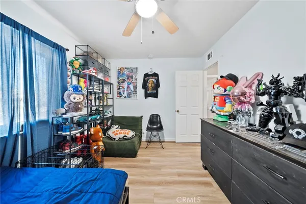 a bed room with a bed a desk and a chandelier