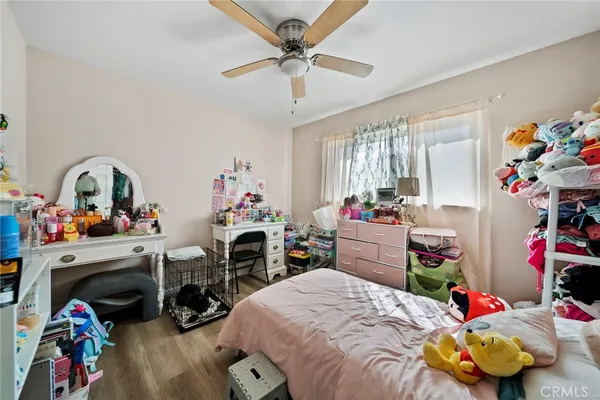 a bedroom with furniture a small book shelf and a couch