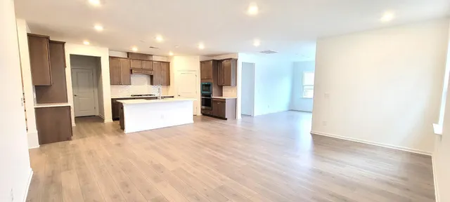 a view of a kitchen with a sink and a refrigerator