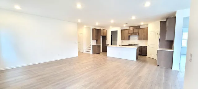 a view of kitchen with stainless steel appliances a refrigerator and a stove top oven