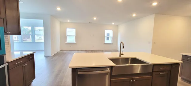 a kitchen with a sink a microwave and cabinets