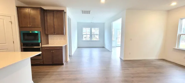 a view of a kitchen cabinets and wooden floor