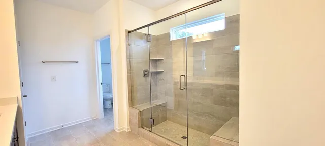 a bathroom with a glass shower door