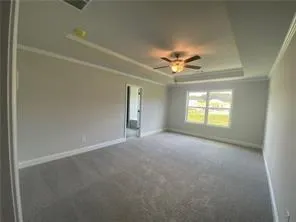 an empty room with a window and a ceiling fan