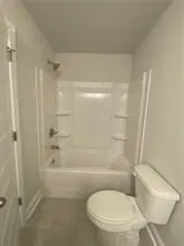 a bathroom with a toilet and shower