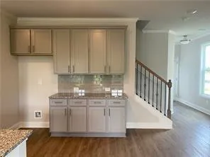a view of a kitchen with wooden floor and cabinets
