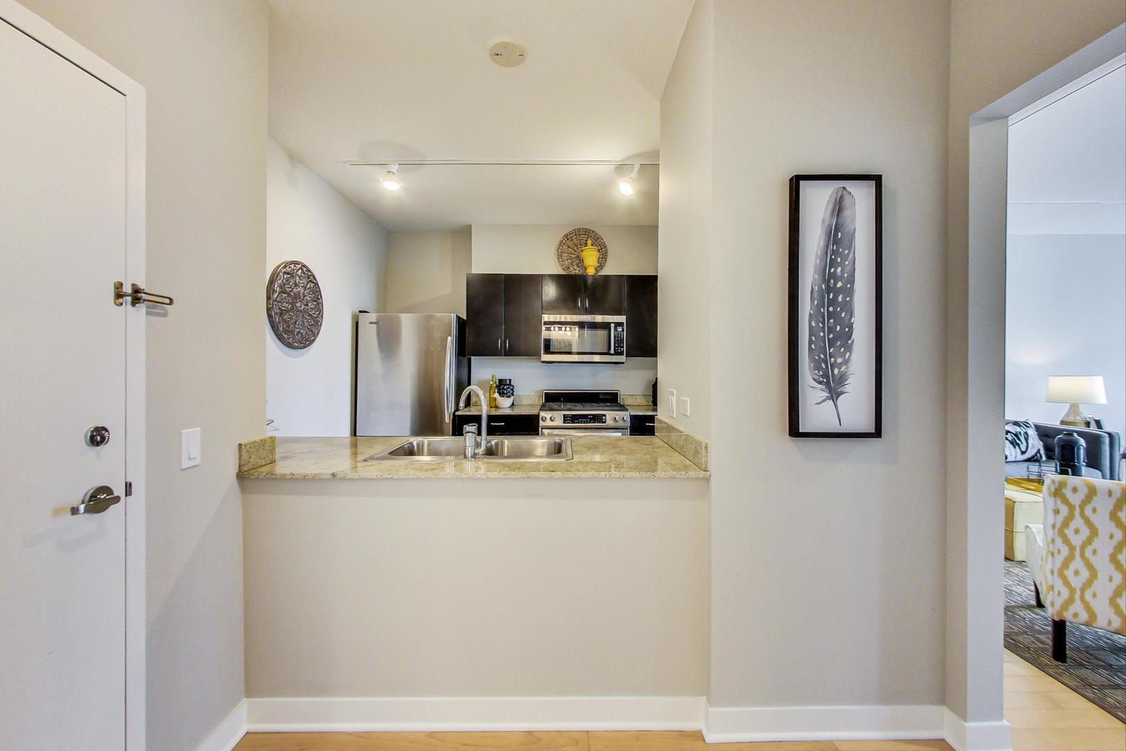 8 East Randolph Street, Unit 2207 Chicago, IL 60601 - Photo 12 of 29 a view of a kitchen with kitchen island a counter top space stainless steel appliances and cabinets