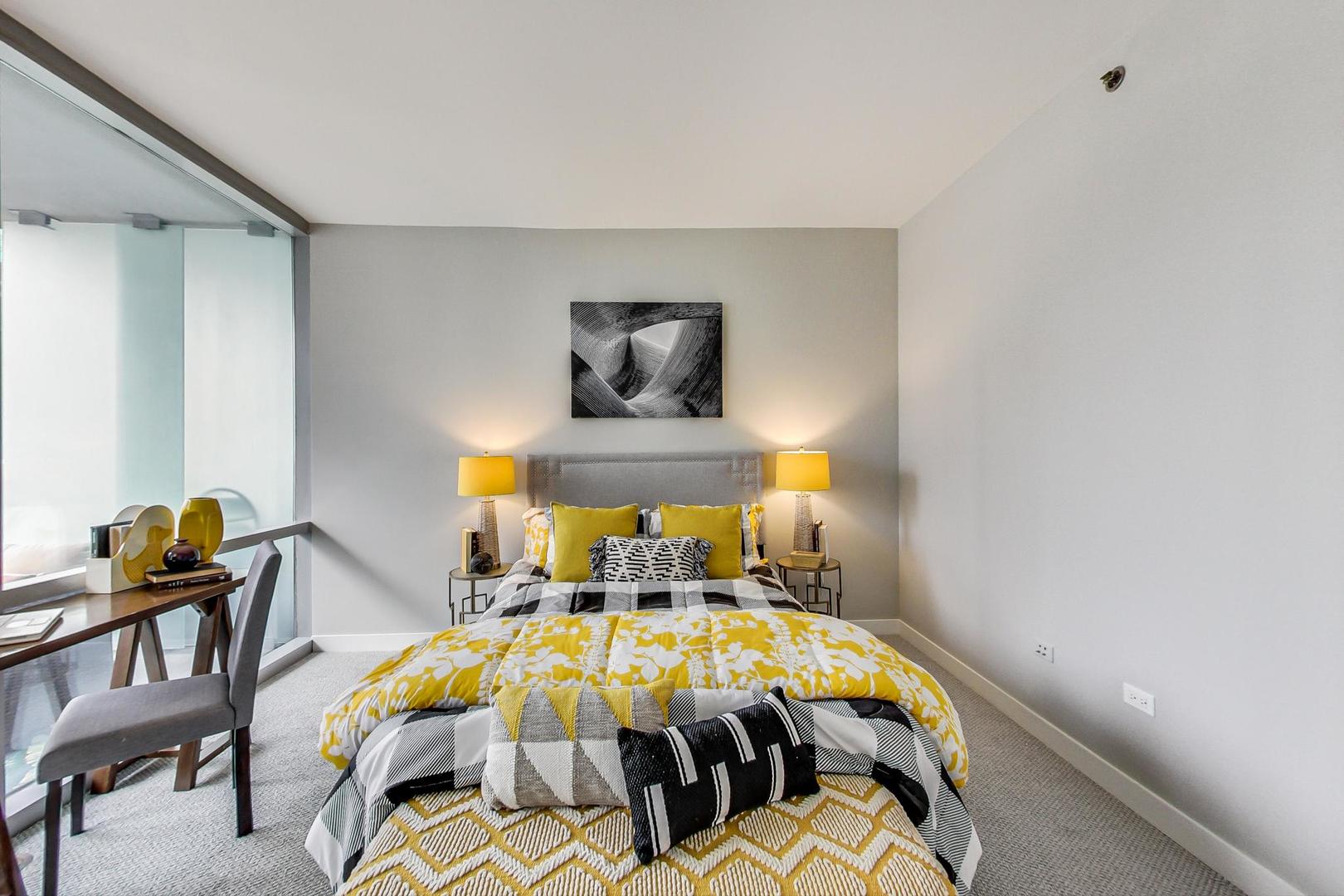 8 East Randolph Street, Unit 2207 Chicago, IL 60601 - Photo 16 of 29 a bed sitting in a bedroom next to a window