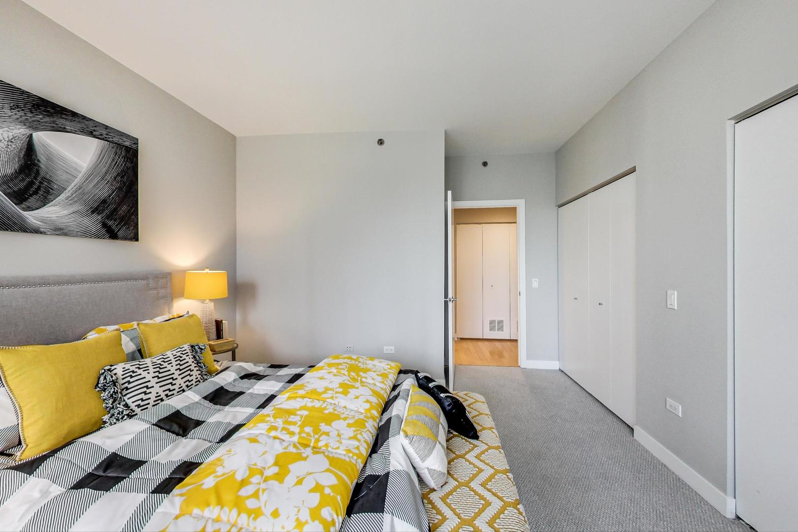 8 East Randolph Street, Unit 2207 Chicago, IL 60601 - Photo 17 of 29 a bedroom with a bed and painting on the wall