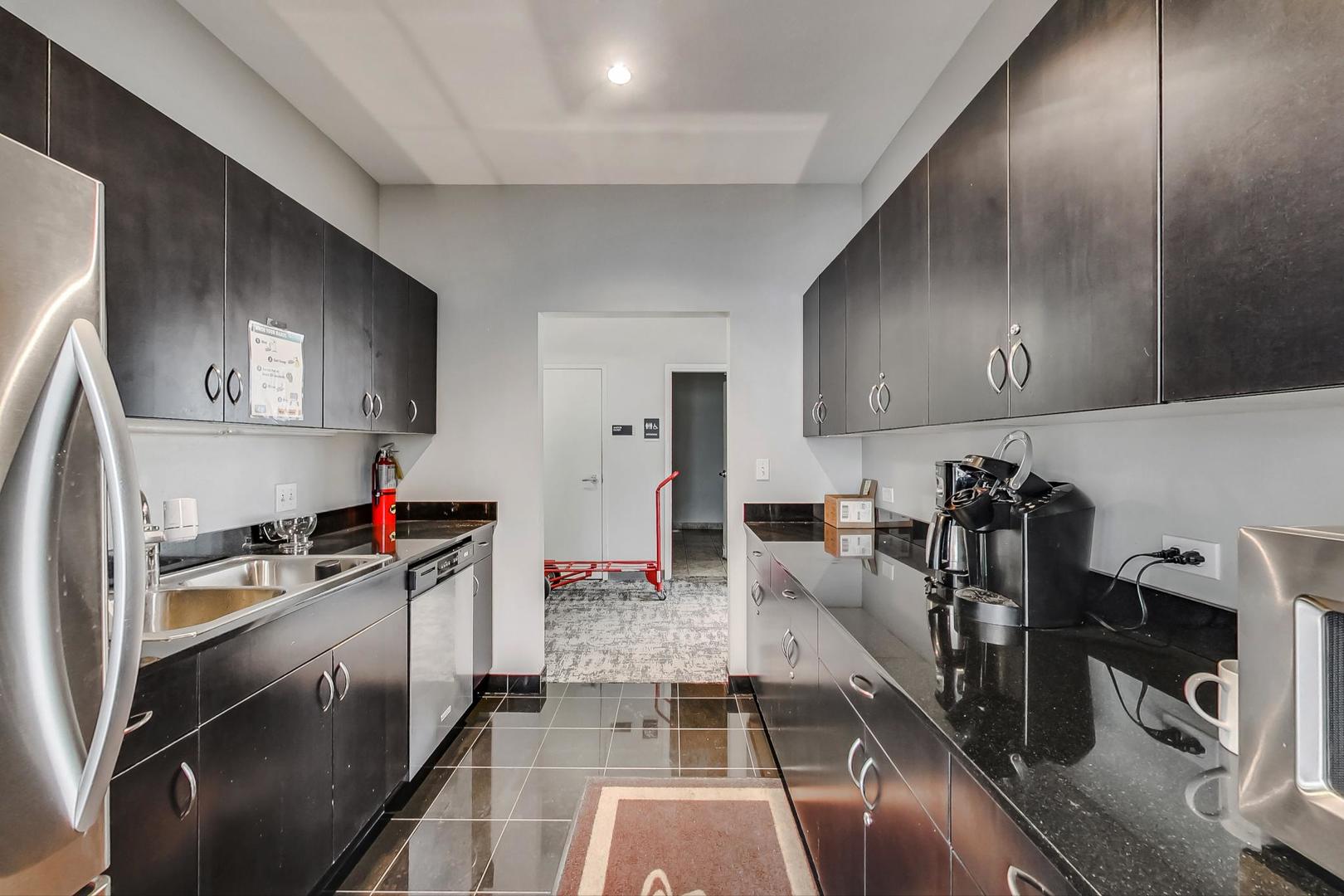 8 East Randolph Street, Unit 2207 Chicago, IL 60601 - Photo 26 of 29 a kitchen with stainless steel appliances granite countertop a sink stove and refrigerator
