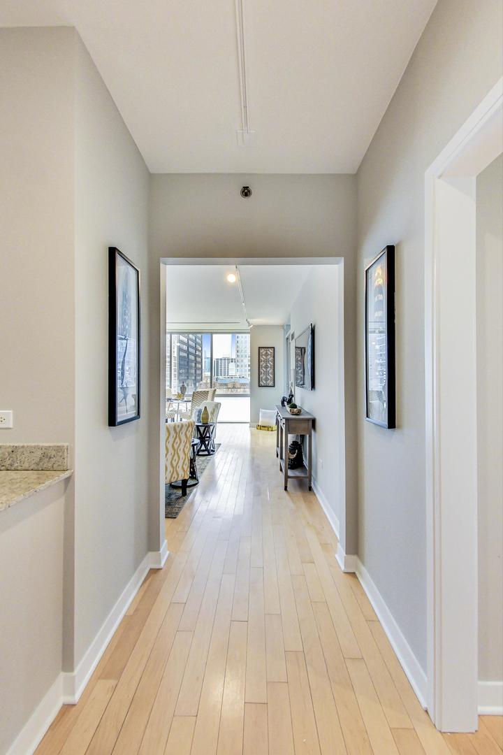 8 East Randolph Street, Unit 2207 Chicago, IL 60601 - Photo 4 of 29 a living room with furniture and a wooden floor