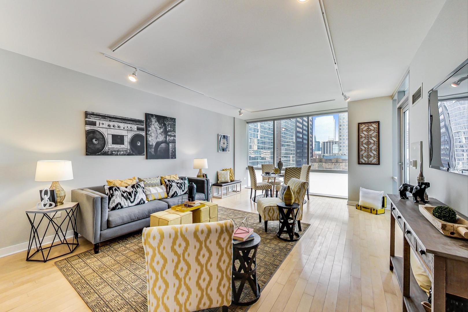8 East Randolph Street, Unit 2207 Chicago, IL 60601 - Photo 5 of 29 a living room with furniture large window and a table
