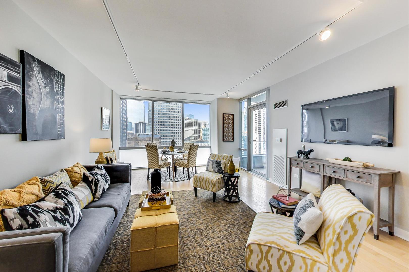 8 East Randolph Street, Unit 2207 Chicago, IL 60601 - Photo 6 of 29 a living room with furniture and a large window