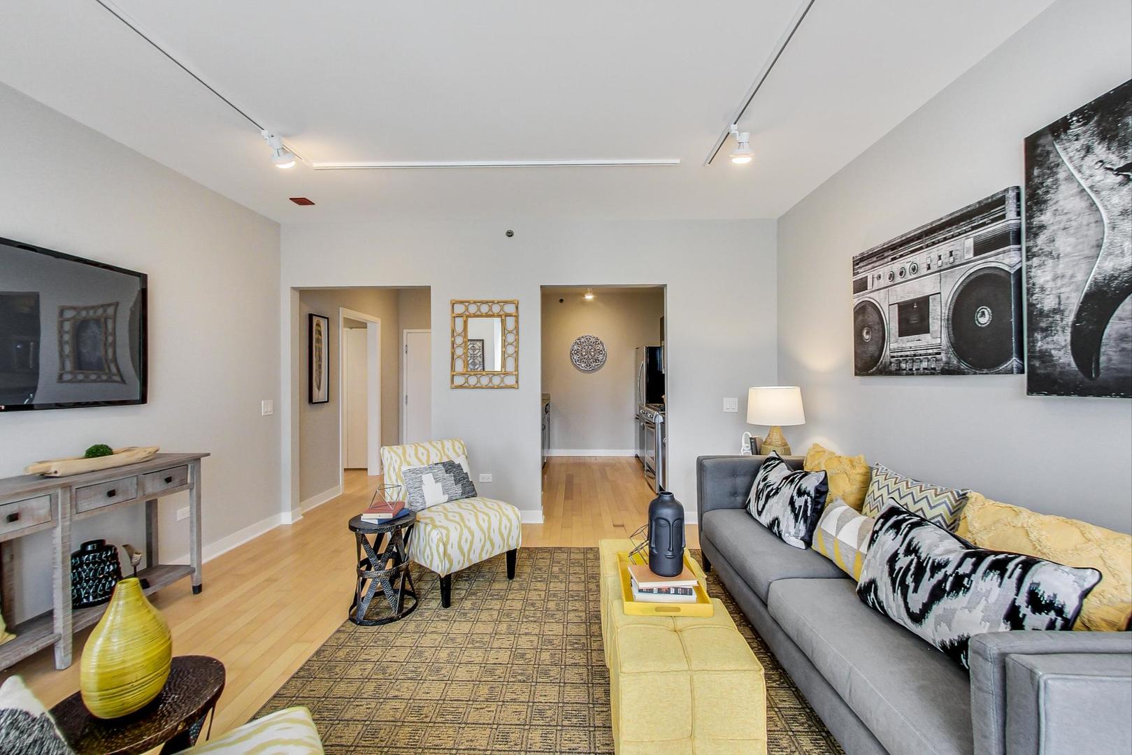 8 East Randolph Street, Unit 2207 Chicago, IL 60601 - Photo 7 of 29 a living room with furniture and a fireplace