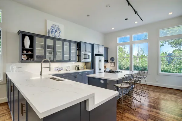 a kitchen with stainless steel appliances kitchen island granite countertop a sink and cabinets