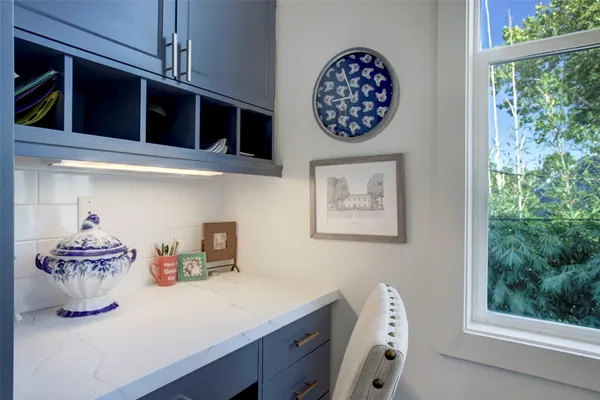 a view of a kitchen with a fridge and a window