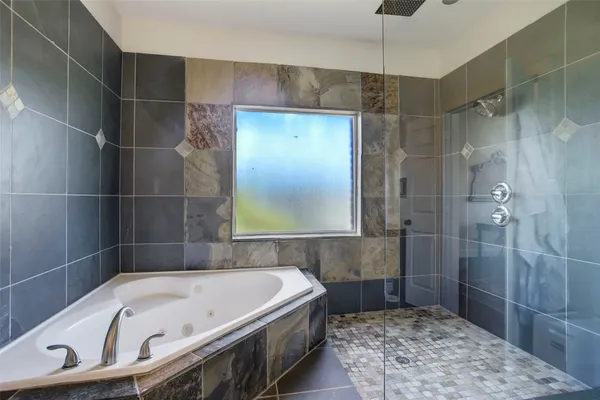 a bathroom with a bathtub and a shower