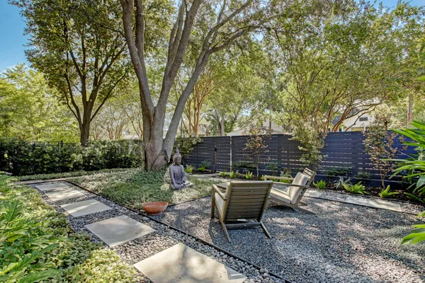 a backyard of a house with table and chairs