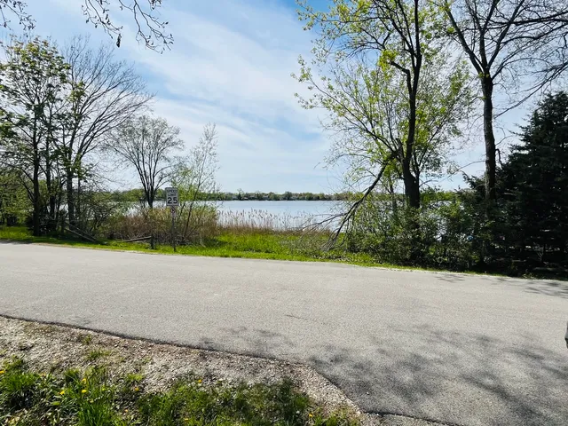a view of a green field with lots of trees