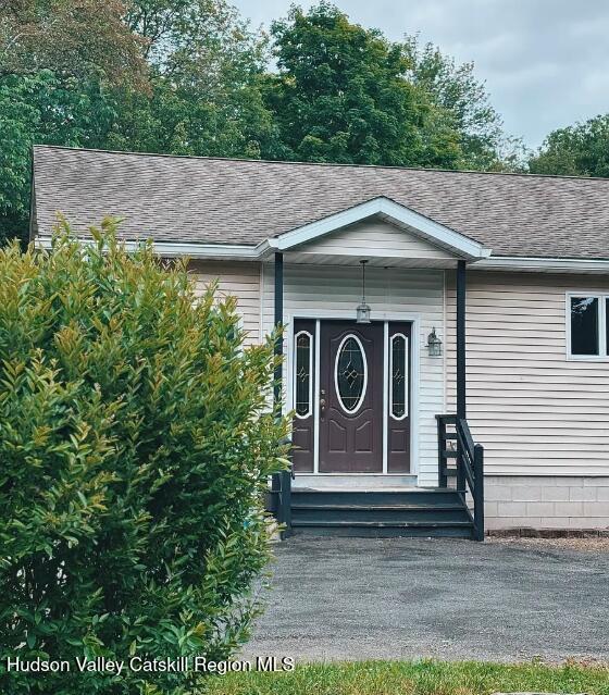 a wooden house with a sign broad