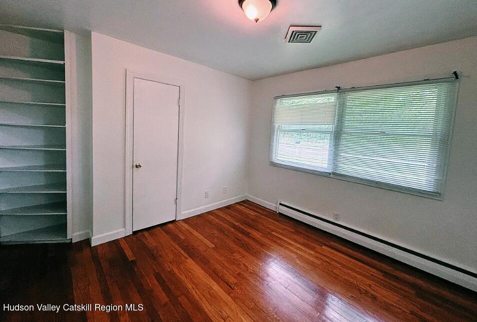 124 Blue Mountain Road Saugerties, NY 12477 - Photo 11 of 14 a view of an empty room with wooden floor and a window
