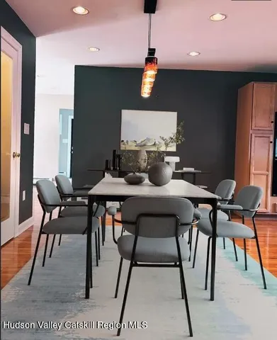 a dining room with furniture and wooden floor