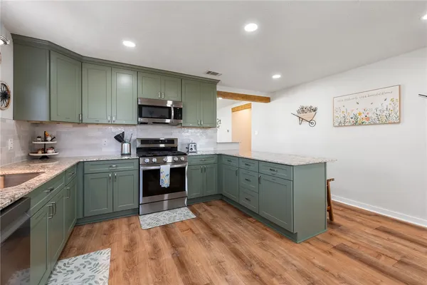 a kitchen with a sink stove and microwave