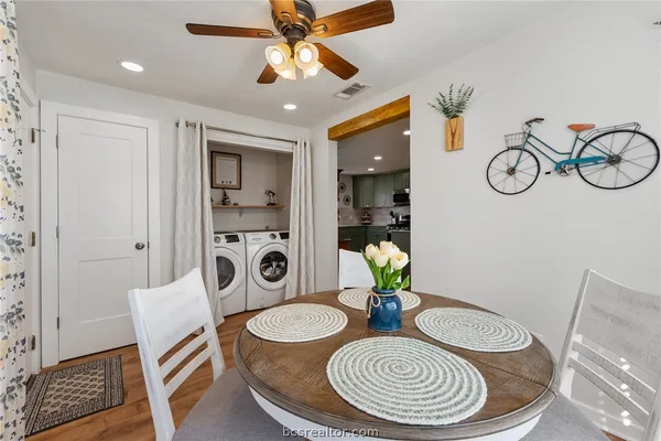 a dining room with furniture a rug and wooden floor