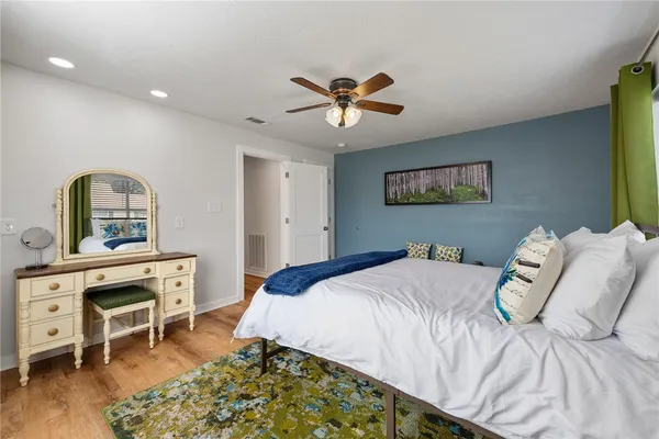 a bedroom with a bed desk and a window