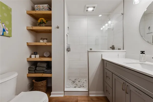 a bathroom with a sink a toilet and a mirror