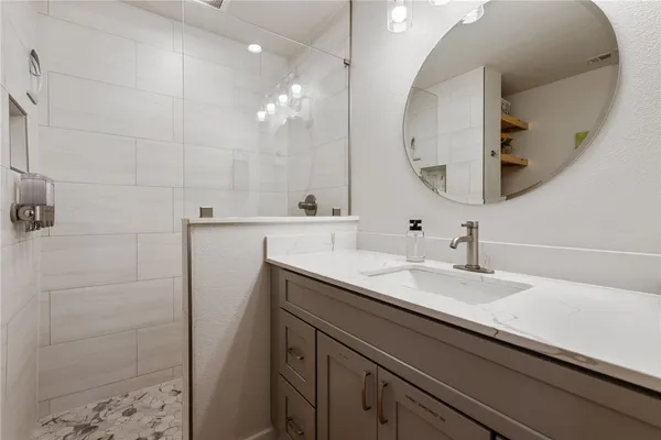 a bathroom with a sink a vanity and a mirror