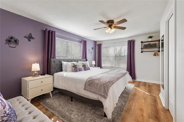 a bedroom with a large bed and a chandelier